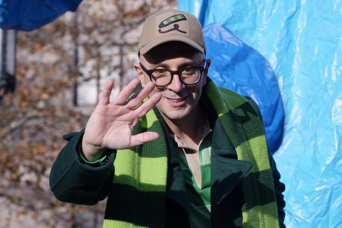 Steve Burns of 'Blue's Clues' waves while clad in a green striped scarf, green jacket and light brown baseball cap