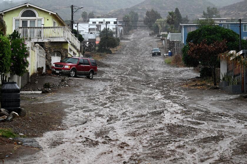 Ensenada, Mexico August 19, 2023-A street is covered in mud as Tropical Storm Hilary makes landfall in Ensenada, Mexico Sunday.`(Wally Skalij/Los Angles Times)