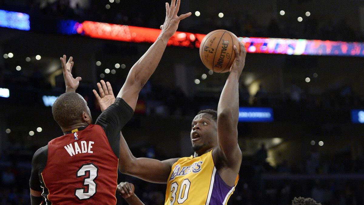 Heat guard Dwyane Wade can't prevent Lakers forward Julius Randle from making the game-winning shot in overtime on Wednesday.