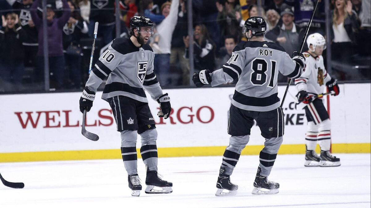 Kings forward Michael Amadio, left, celebrates with teammate Matt Roy after scoring during the third period of a 3-2 victory over the Chicago Blackhawks on Saturday.
