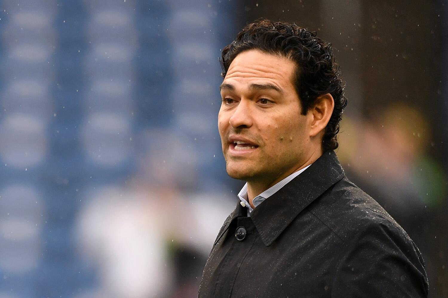 Fox Sports analyst Mark Sanchez walks on the field before a 2023 game between the Rams and Seahawks in Seattle.