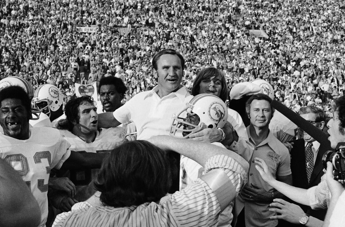 FILE - Miami Dolphins coach Don Shula, center, is carried off the field after his team won the NFL football Super Bowl game over Washington Redskins in Los Angeles, Jan. 14, 1973. It can be argued — and has been for decades — that a perfect record including winning a championship makes that team the best in its sport. And maybe the 1972 Miami Dolphins wouldn't have matched up with, say, the great Steelers dynasty of the later 1970s. Or the dominant 49ers of the 1980s. Or the Cowboys Triplets of the 1990s. No matter: Miami owns the only unblemished record in the Super Bowl era. (AP Photo/File)