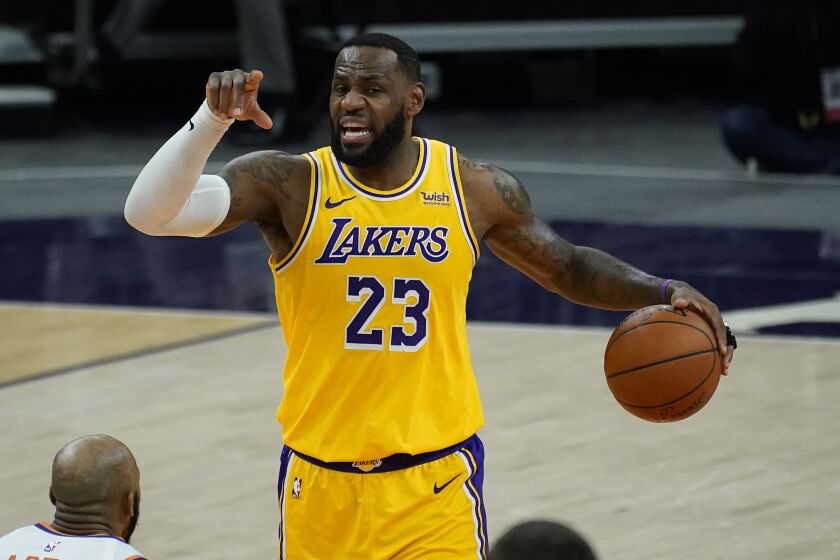 Los Angeles Lakers forward LeBron James (23) calls a play against the Phoenix Suns during the first half of a preseason basketball game, Friday, Dec. 18, 2020, in Phoenix, Ariz. (AP Photo/Matt York)