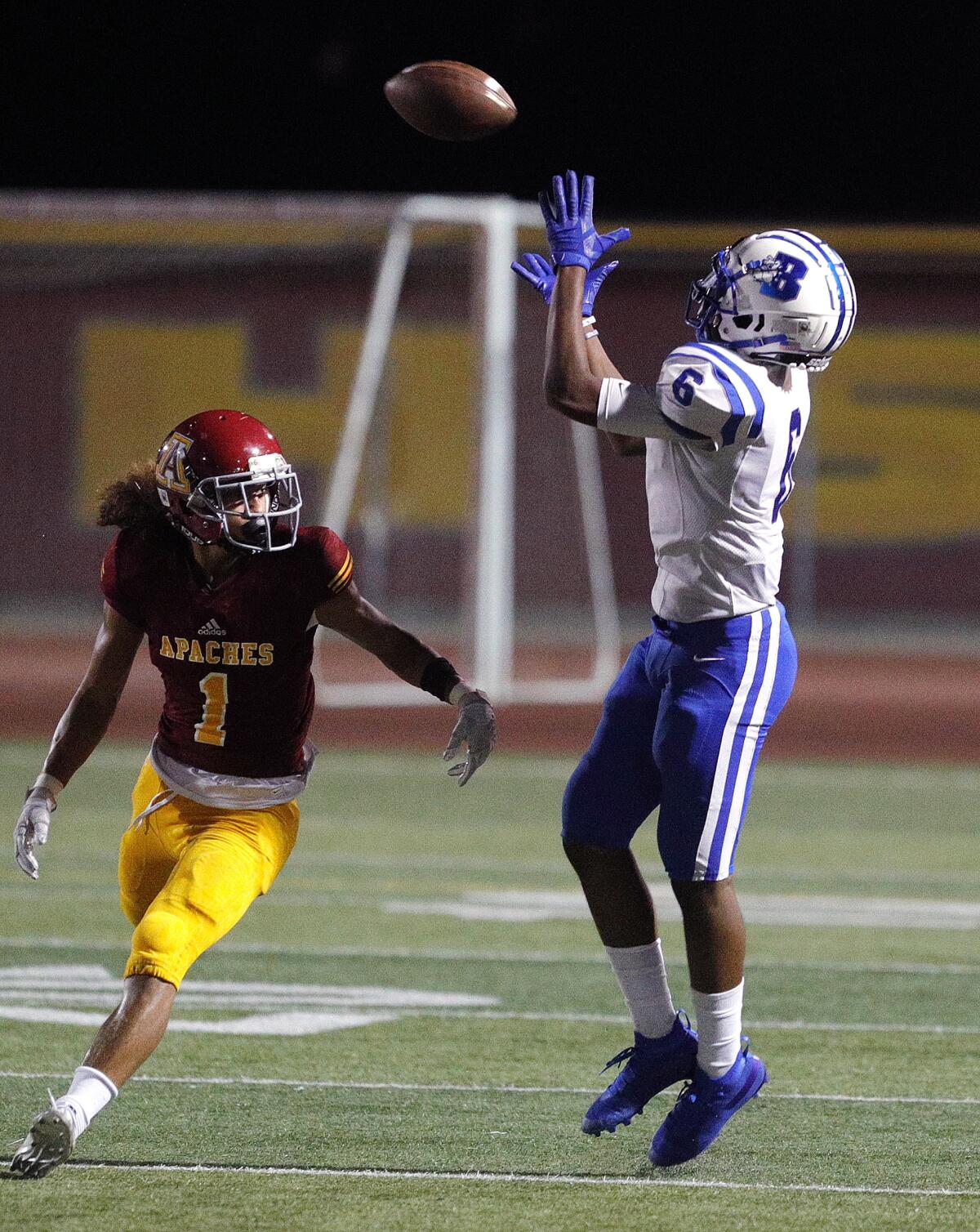 Burbank's Jarren Flowers catches the ball over Arcadia's Ty Cavallero in a Pacific League football opener at Arcadia High School on Thursday, September 19, 2019.