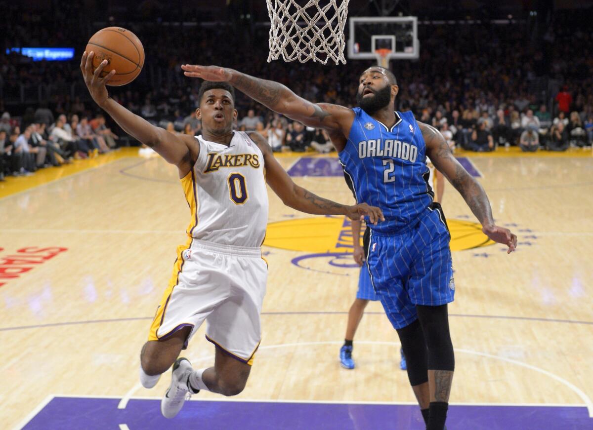 Lakers forward Nick Young has his layup challenged by Magic forward Kyle O'Quinn during a game last season.