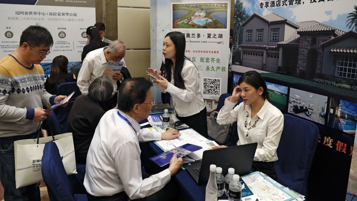 Chinese visitors seek information of the U.S. government's EB-5 visa program in Beijing on May 7, 2017.