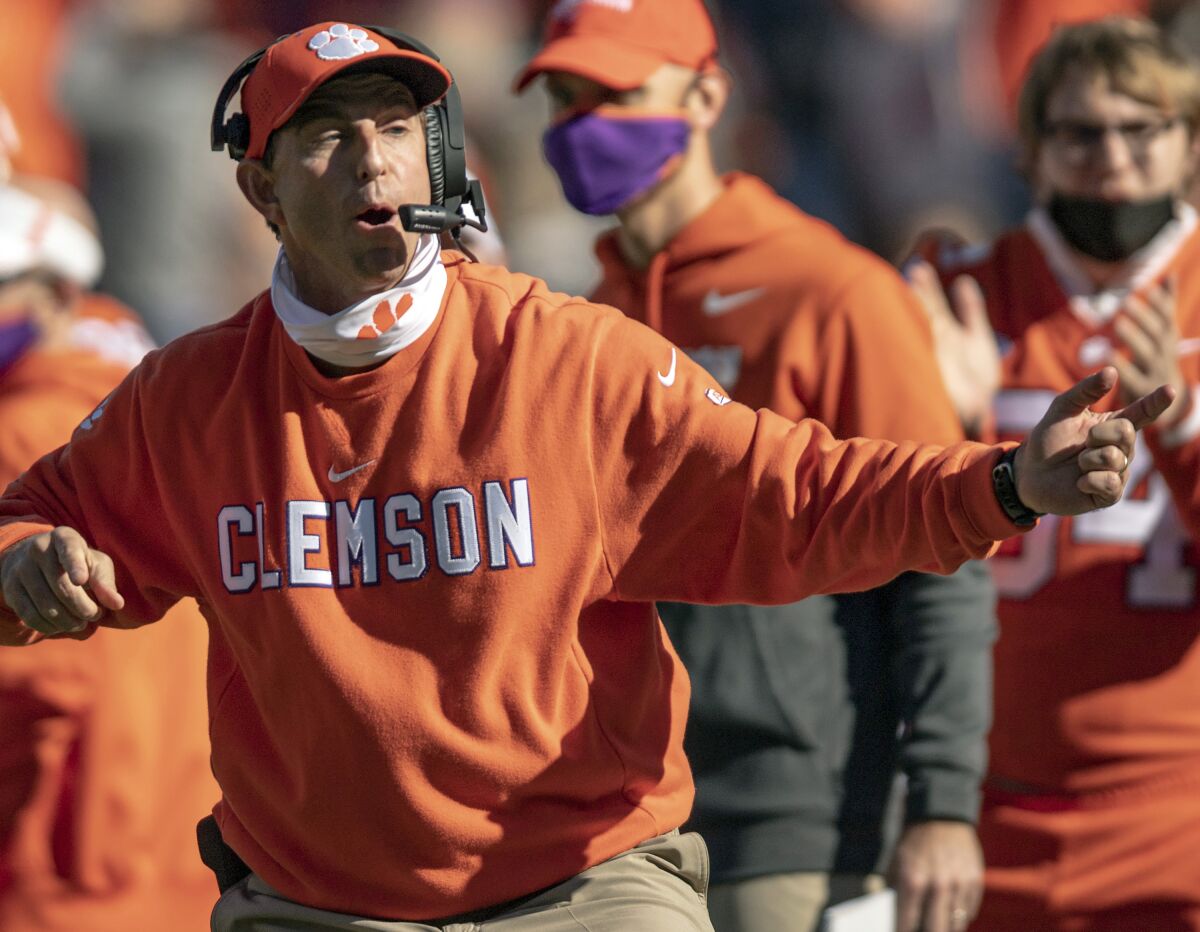 FILE - In this Oct. 31, 2020, file photo, Clemson head coach Dabo Swinney talks with players during the second half of an NCAA college football game against Boston College, Saturday, Oct. 31, 2020, in Clemson, S.C. Swinney, the coach of No. 3 Clemson, faces No. 5 Georgia in the season-opener in Charlotte, N.C. (Josh Morgan/Pool Photo via AP, File)