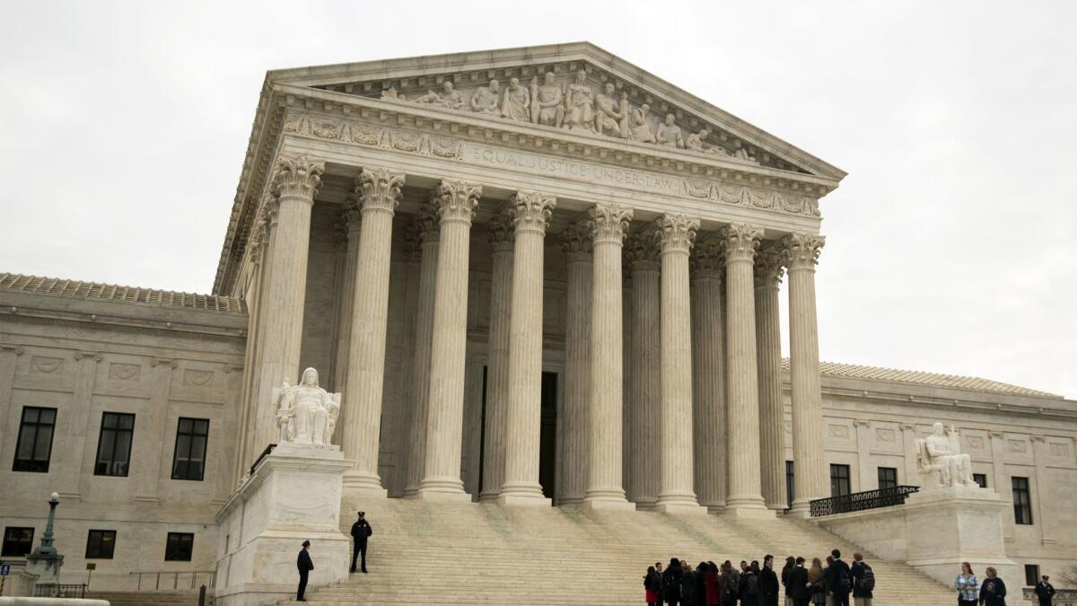 People wait outside the U.S. Supreme Court on Wednesday.
