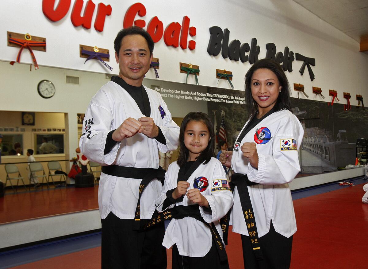 Hugh, Stella, 9, and Tessa Yao, all first degree black belts, at JK Tai Kwon Do in Glendale on Tuesday, January 7, 2014. The three became black belts in December after completing a 7 hour advancement test, ending the test by breaking, with their hands, a block of concrete.