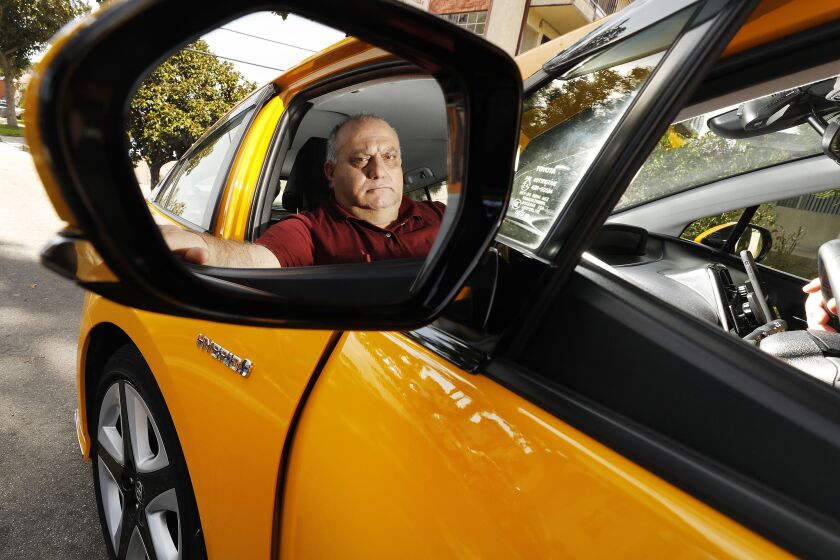 GLENDALE, CA - JANUARY 24, 2020 Varuzhan Shahazizyan quit driving for the yellow cab company, pulled off the cab markings and now drives his bright yellow Pius for Lyft because of the impact of LAX pickup changes. (Al Seib / Los Angeles Times)