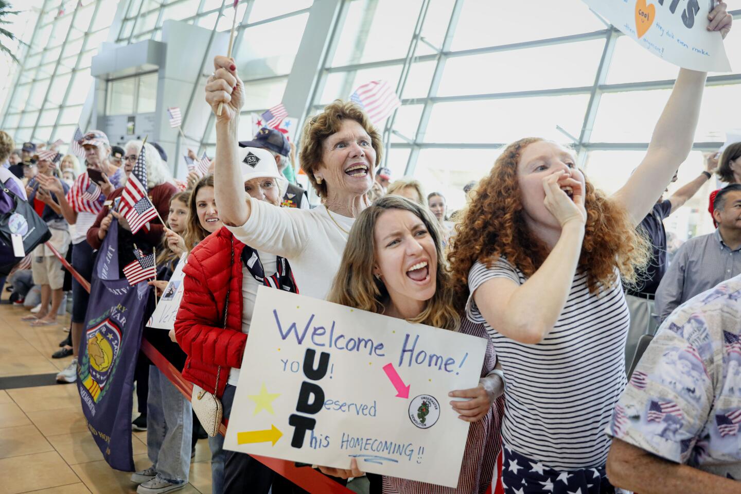 Well wishers greet Navy Vets after arriving back in San Diego from an Honor Flight tour, at the San Diego International Airport on Sunday, April 28, 2024.