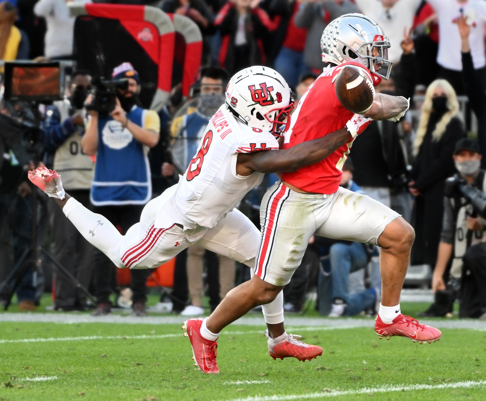 Utah cornerback Clark Phillips strips the ball away from Ohio State wide receiver Jason Smith-Njigba.