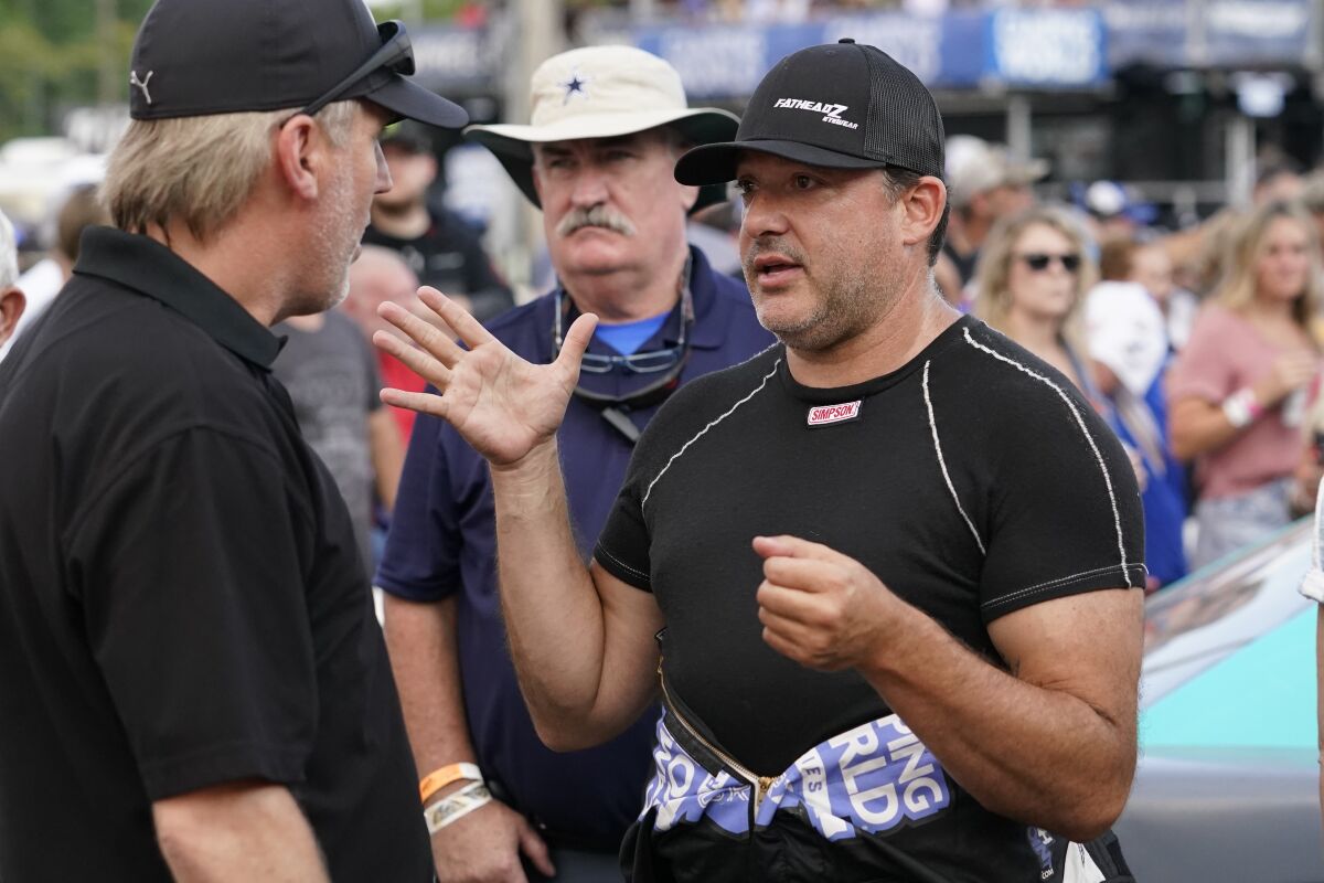 FILE - Tony Stewart talks before an SRX Series auto race in Nashville, in this Saturday, July 17, 2021, file photo. Stewart, who fell in love with NHRA while tagging along with fiancée Leah Pruett at her races the past two seasons, will be an official part of the sport in 2022. The NASCAR Hall of Fame driver will add two fulltime NHRA entries to Tony Stewart Racing next season — a Top Fuel entry for Pruett and a Funny Car for Matt Hagan. (AP Photo/Mark Humphrey, File)