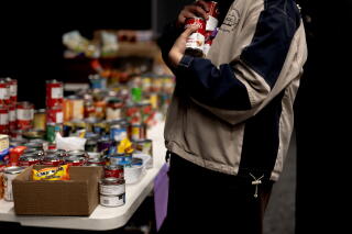 A volunteer organizes donated items for distribution