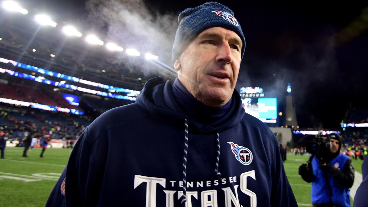 Mike Mularkey leaves the field after coaching the Tennessee Titans against the New England Patriots in an AFC divisional playoff game on Saturday.