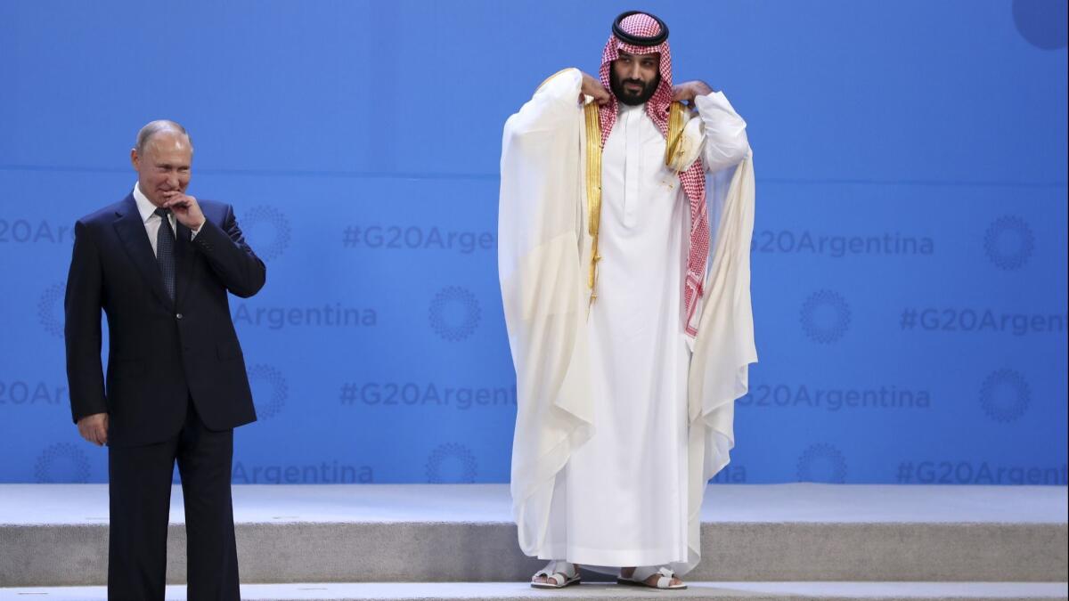 Crown Prince Mohammed bin Salman waits for the G-20 group photo in Buenos Aires in November 2018, with only Russian President Vladimir Putin near him. It was the Saudi prince's first major overseas appearance since the killing of a dissident journalist who lived in the U.S.