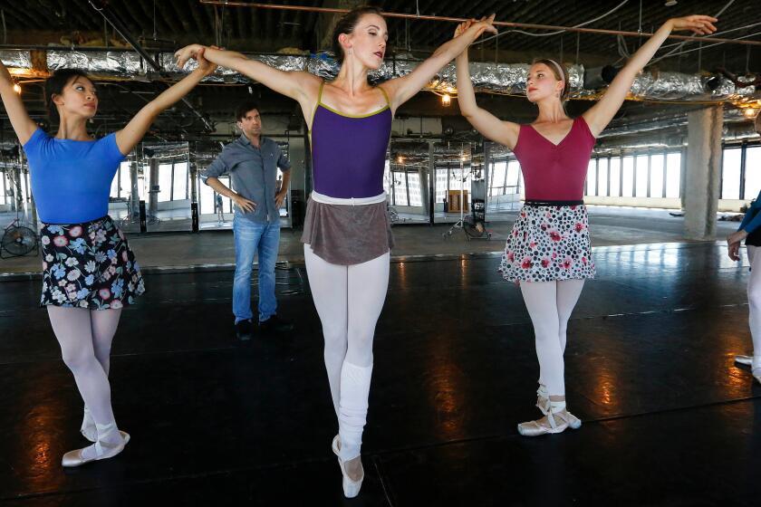 American Contemporary Ballet dancer Emily Parker, flanked by Rochelle Chang, left, and Raffaella Stroik, rehearses under the eye of choreographer Lincoln Jones.