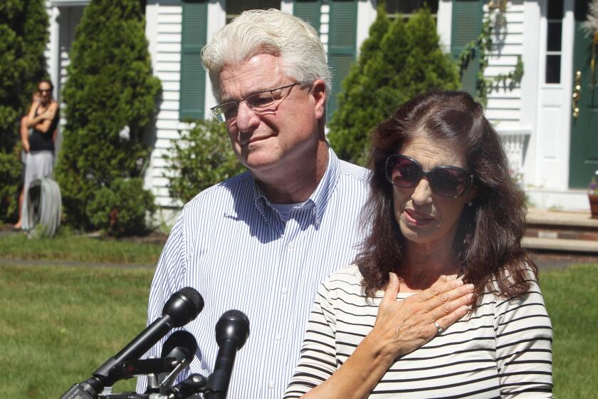 Diane and John Foley talk to reporters outside their home in Rochester, N.H., after speaking with President Obama on Wednesday.