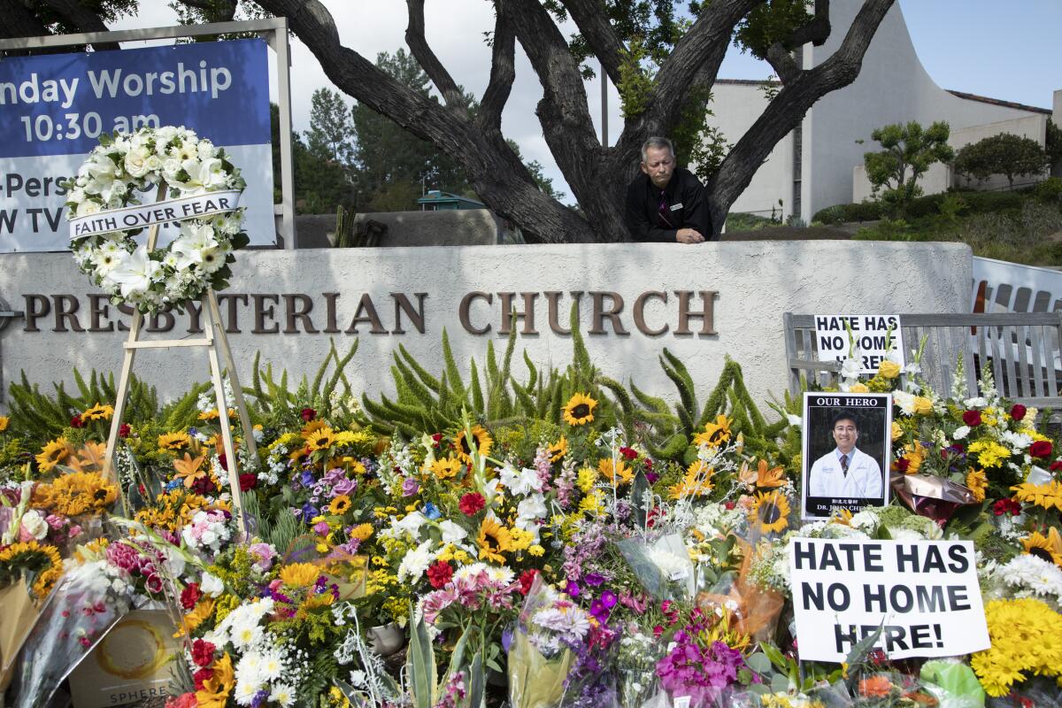 A sidewalk memorial outside the Laguna Woods church where a gunman shot six people in May 2022.