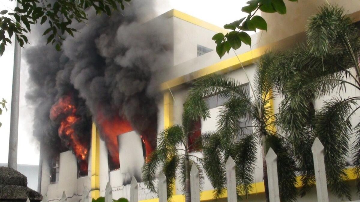 Smoke and flames billow from a factory window in Binh Duong, Vietnam after anti-China protesters set more than a dozen factories on fire.