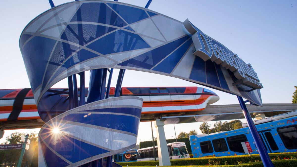 The Disneyland Monorail passes the Disneyland entrance sign at the East Shuttle Area and South Harbor Boulevard in Anaheim in September. The theme park has put plans for a new transportation center on its eastern edge on hold.