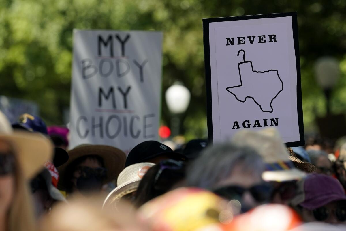 Abortion rights demonstrators hold signs during a rally at the Texas Capitol in Austin in 2022.