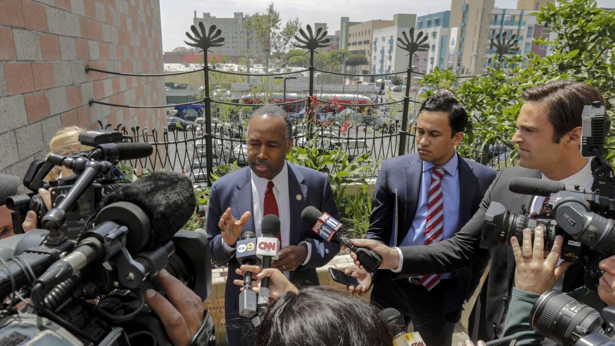 HUD Secretary Ben Carson, left, speaks to the media while visiting the Downtown Women's Center in Los Angeles on April 24.