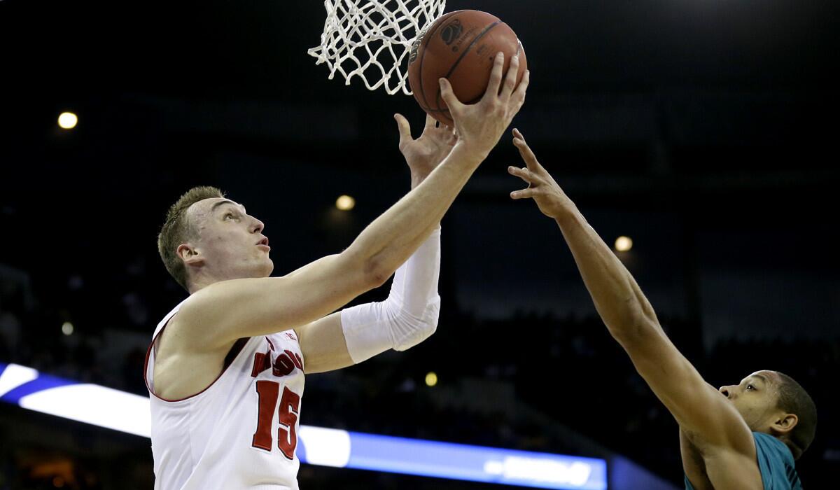 Wisconsin forward Sam Dekker drives to the basket against Coastal Carolina guard Elijah Wilson during the Badgers' 86-72 win over Chanticleers on Friday in the second round of the NCAA tournament.