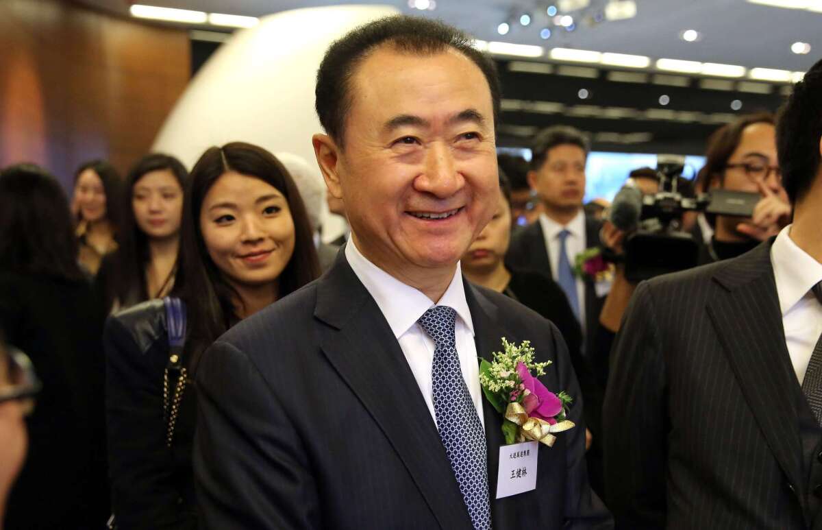 Wang Jianlin, chief executive of Dalian Wanda Commercial Properties, arrives before the company's IPO at the Hong Kong Stock Exchange on Dec. 23, 2014. Wanda is the owner of China’s largest theater chain.