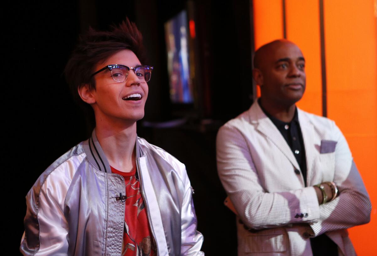 "American Idol" contestant Mackenzie Bourg, left, and vocal coach Dorian Holley take five during a dress rehearsal for the March 24 episode at CBS Television City in Hollywood.