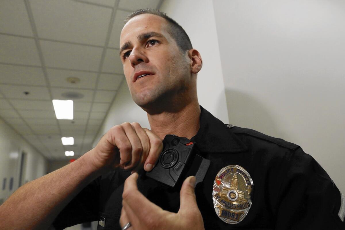 LAPD Officer Jim Stover demonstrates the body camera at the Mission Division.