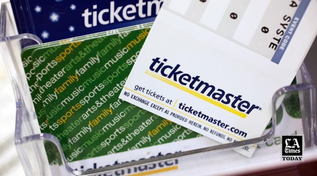 A Ticketmaster ticket and cards in a clear container.