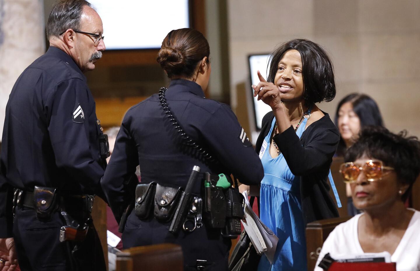 Yvonne Michelle Autry, right, is ejected during a City Council meeting.