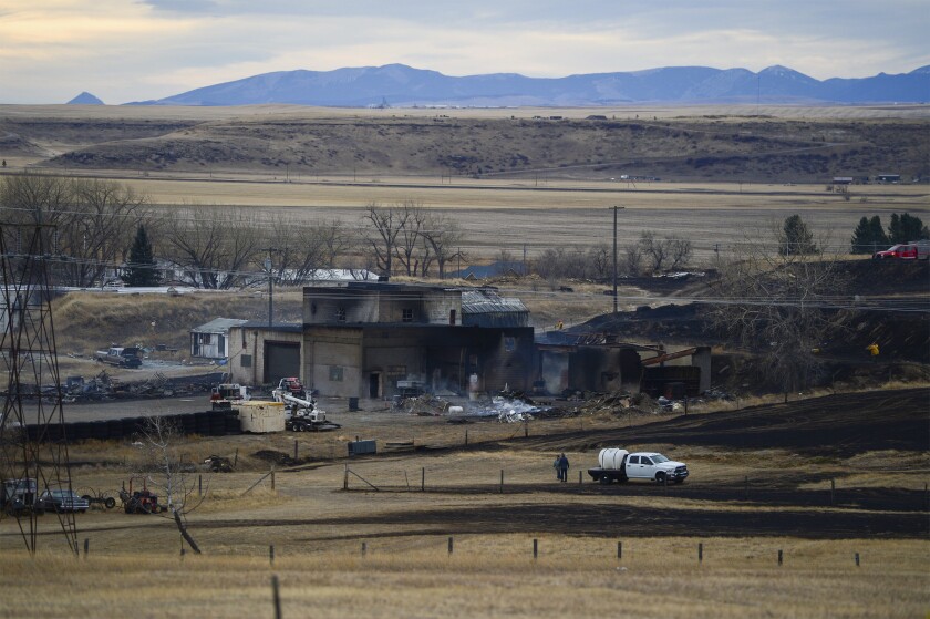 A fire burned through the Gibson Flats area south of Great Falls, Mont., on Wednesday, Dec. 1, 2021, destroying 11 homes, seven garages and 11 outbuildings, fire officials said. The fire was one of three wind-driven fires on Wednesday that forced evacuations in Montana. A fire near Denton led hundreds of residents to flee the central Montana town on Wednesday. Some buildings in the town were on fire. Another grass fire forced temporary evacuations near Browning, east of Glacier National Park. (Rion Sanders/The Great Falls Tribune via AP)