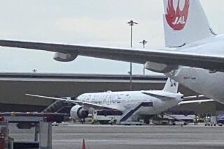 The Boeing 777-300ER aircraft of Singapore Airlines, flight SQ321 from Heathrow is seen on tarmac after requesting an emergency landing at Bangkok's Suvarnabhumi International airport, Thailand, Tuesday, May 21, 2024. One person has died aboard a London-Singapore flight that encountered severe turbulence, Singapore Airlines said Tuesday, in which the plane apparently plummeted for a number of minutes before it was diverted to Bangkok, where emergency crews rushed to help injured passengers amid stormy weather. (Pongsakorn Rodphai via AP)