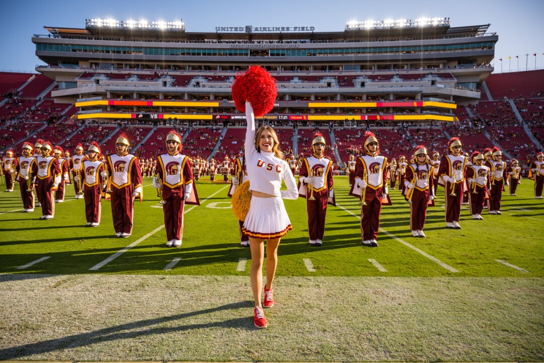 USC Song Girls captain Hannah Shaw cheers in front of the Trojans marching band.
