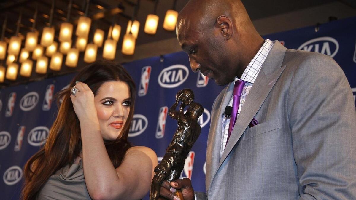 Khloe Kardashian watches her husband, Lamar Odom, then a forward for the Los Angeles Lakers, who received the Sixth Man Award in 2011.