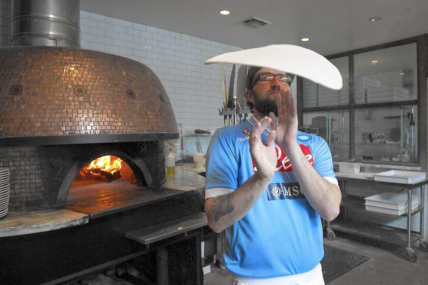Chef Alex Moody spins and flips the dough for a Napoli-style margherita pizza at Settebello in Crystal Cove.