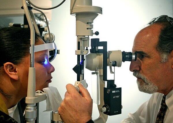 Sophia Taylor, 24, of Long Beach, left, receives an eye examination from Dr. Jay Messinger at his optometry office in Compton. It is the only such office in the city.