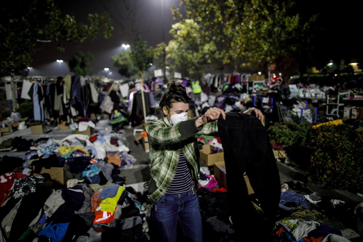 Jessica Sijan volunteers to sort out clothes for evacuees gathered at a Walmart parking lot in Chico in 2018.