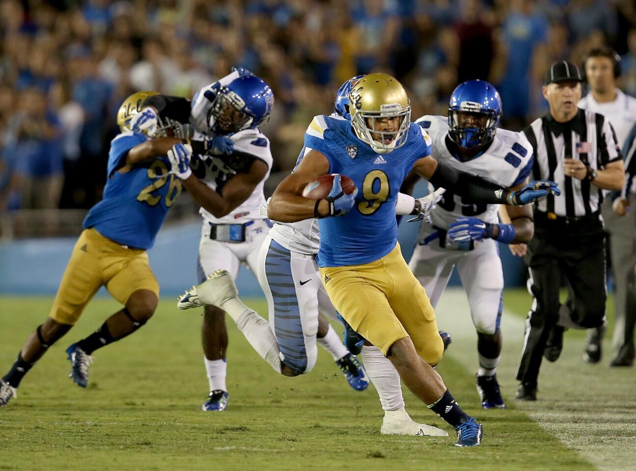 UCLA receiver Jordan Payton finds running room along the sideline after making a catch against Memphis in the third quarter Saturday at the Rose Bowl.