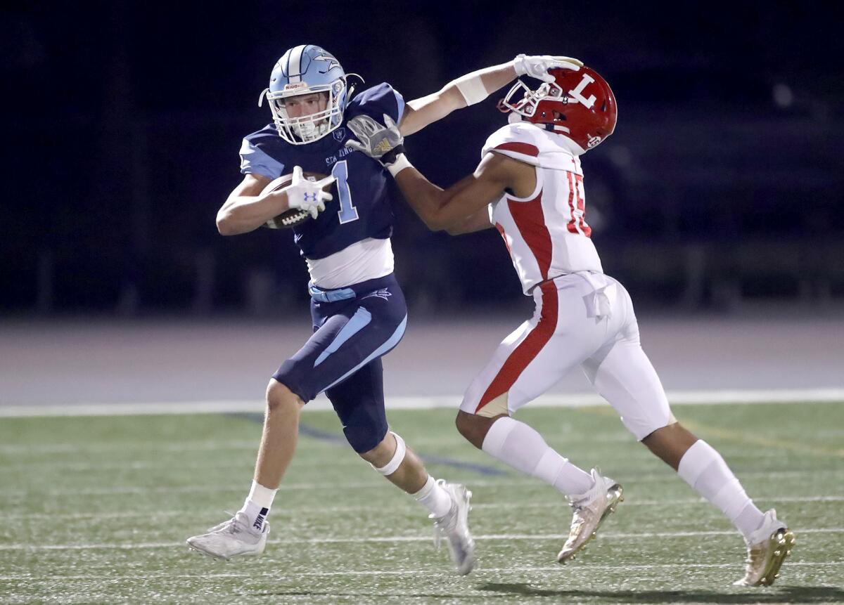 After a catch and run, Corona del Mar's Max Lane eludes a tackle from Xane Uipi during Friday night's game.