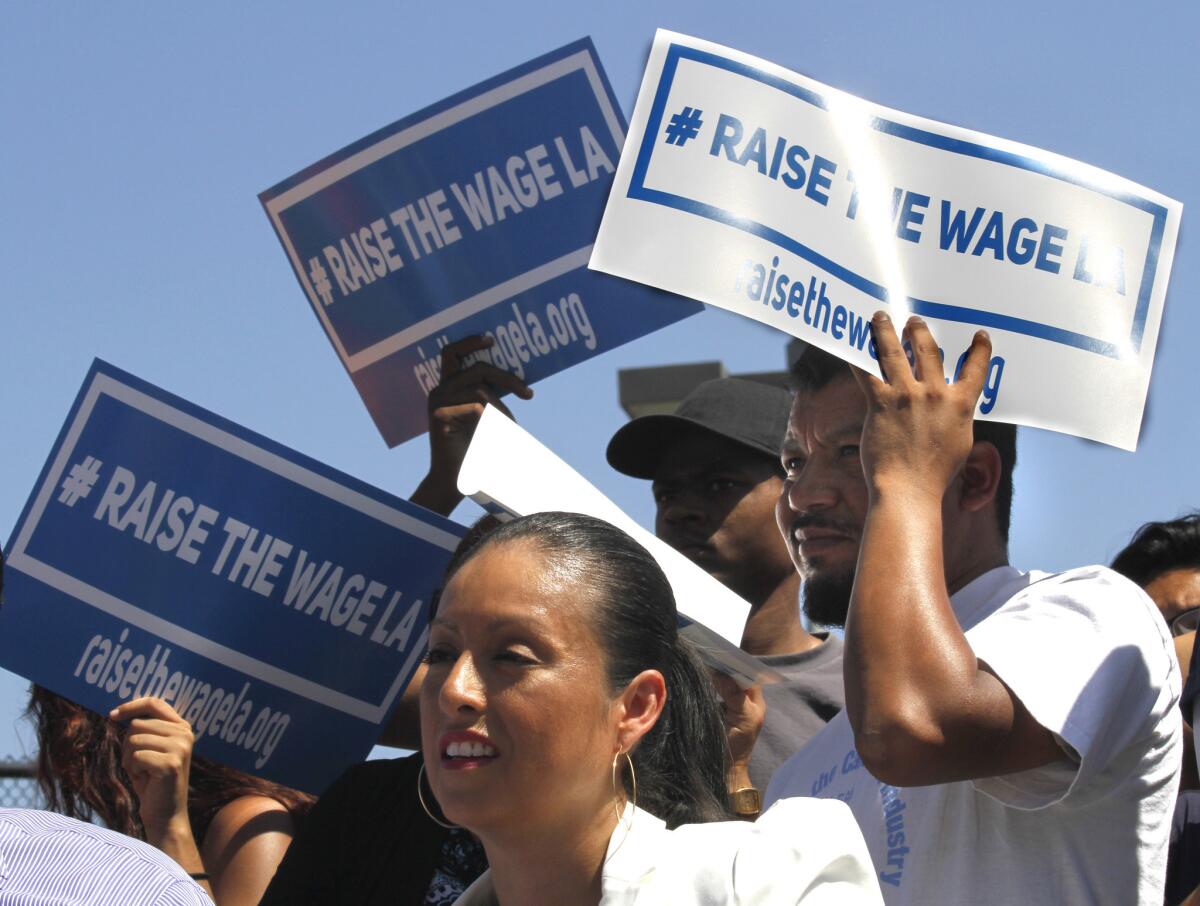 Supporters listen to L.A. Mayor Eric Garcetti announce his plan to raise the minimum wage in the city to more than $13 an hour.