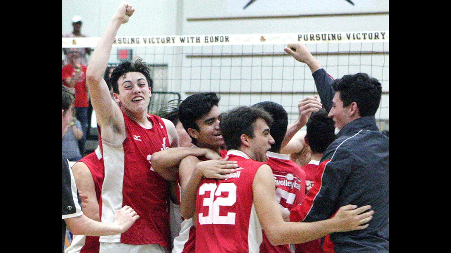 The Burroughs boys' volleyball team celebrates their championship victory against Oak Park in the CIF SoCal Regional Boys' Volleyball Division II championship at Edison High School in Huntington Beach on Saturday, May 28, 2016. Burroughs won the championship match 3-1.