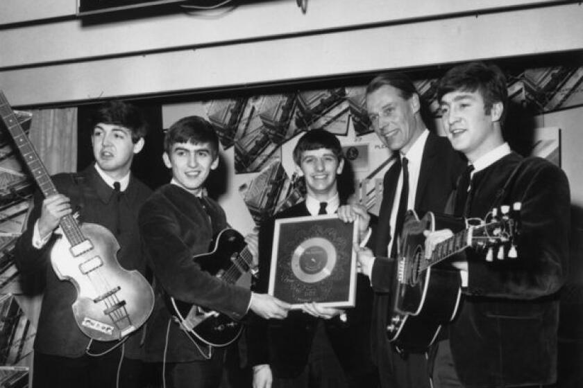 The Beatles, photographed on April 8, 1963, receiving a silver record sales award, are the subject of a new benefit tribute album "Beatles Reimagined" due Oct. 1.