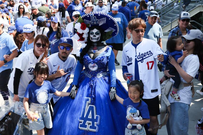 LOS ANGELES, CA - MARCH 28: La Muerta Maria wears a stands with fans before the game.