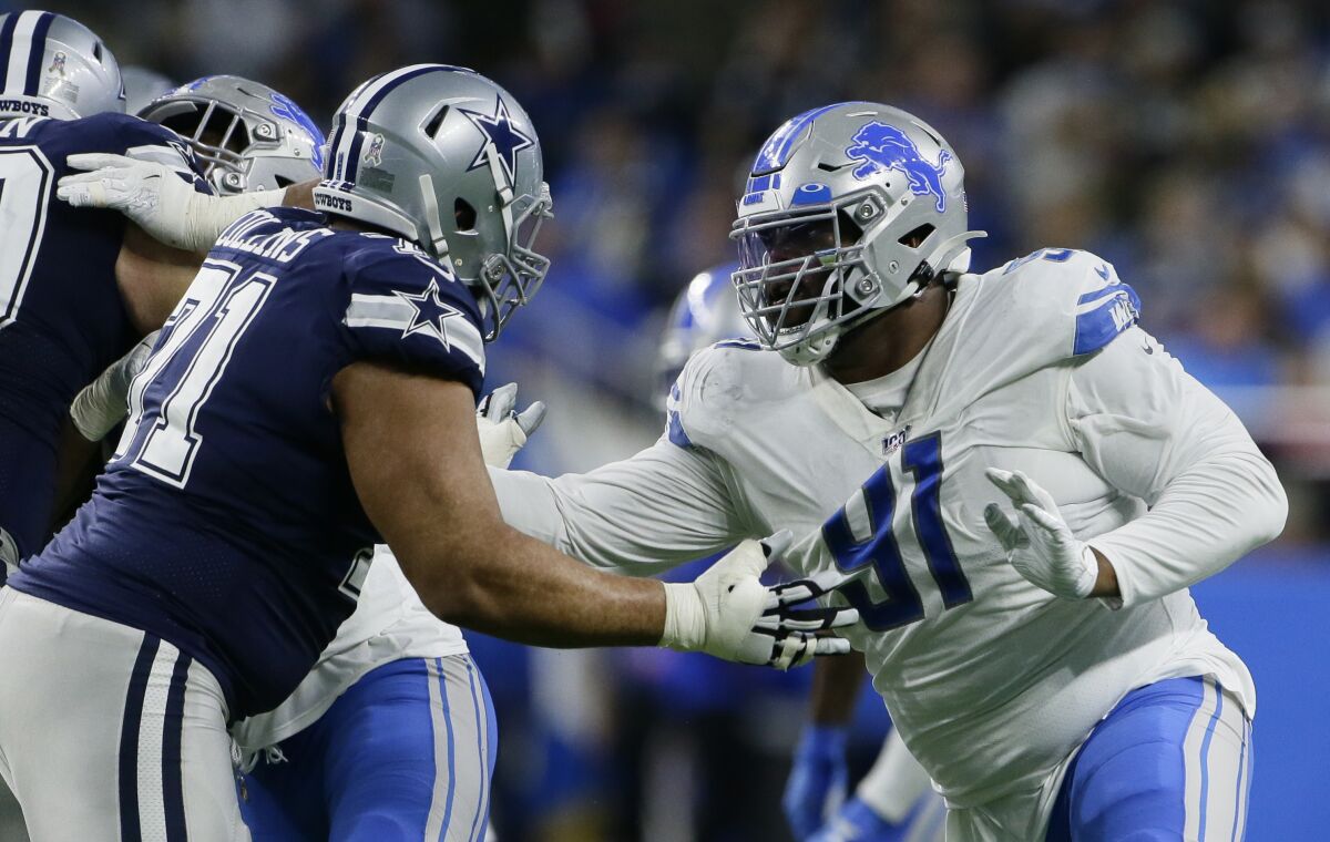 File-Detroit Lions defensive tackle A'Shawn Robinson (91) is blocked by Dallas Cowboys offensive tackle La'el Collins (71) during the second half of an NFL football game, Sunday, Nov. 17, 2019, in Detroit. New Los Angeles Rams defensive tackle Robinson is sidelined indefinitely with a non-football injury, coach Sean McVay says. The Rams put Robinson on the active/non-football injury list Saturday, and McVay discussed their new signee's prognosis Sunday, Aug. 9, 2020, without disclosing the nature of Robinson's condition, which isn't coronavirus-related. (AP Photo/Duane Burleson, File)