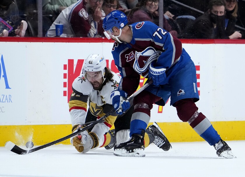 Vegas Golden Knights right wing Mark Stone (61) dives to get the puck from Colorado Avalanche right wing Joonas Donskoi (72) during the third period in Game 2 of an NHL hockey Stanley Cup second-round playoff series Wednesday, June 2, 2021, in Denver. (AP Photo/Jack Dempsey)