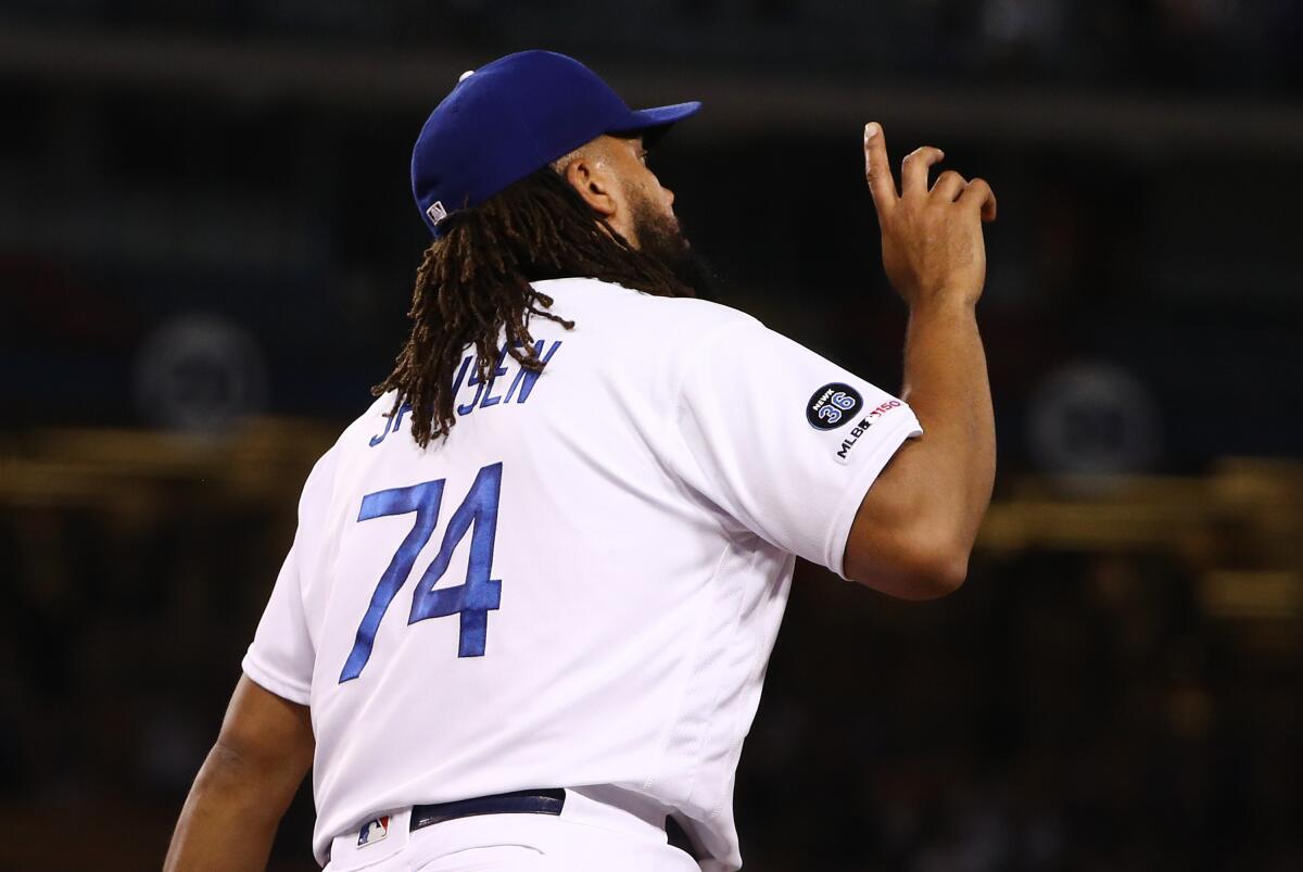 Dodgers closer Kenley Jansen points to the sky after the final out.