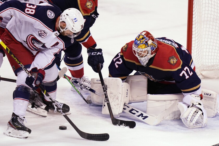 Columbus Blue Jackets center Boone Jenner (38) looks for a shot on Florida Panthers goaltender Sergei Bobrovsky (72) during the first period of an NHL hockey game Saturday, April 3, 2021, in Sunrise, Fla. (AP Photo/Wilfredo Lee)